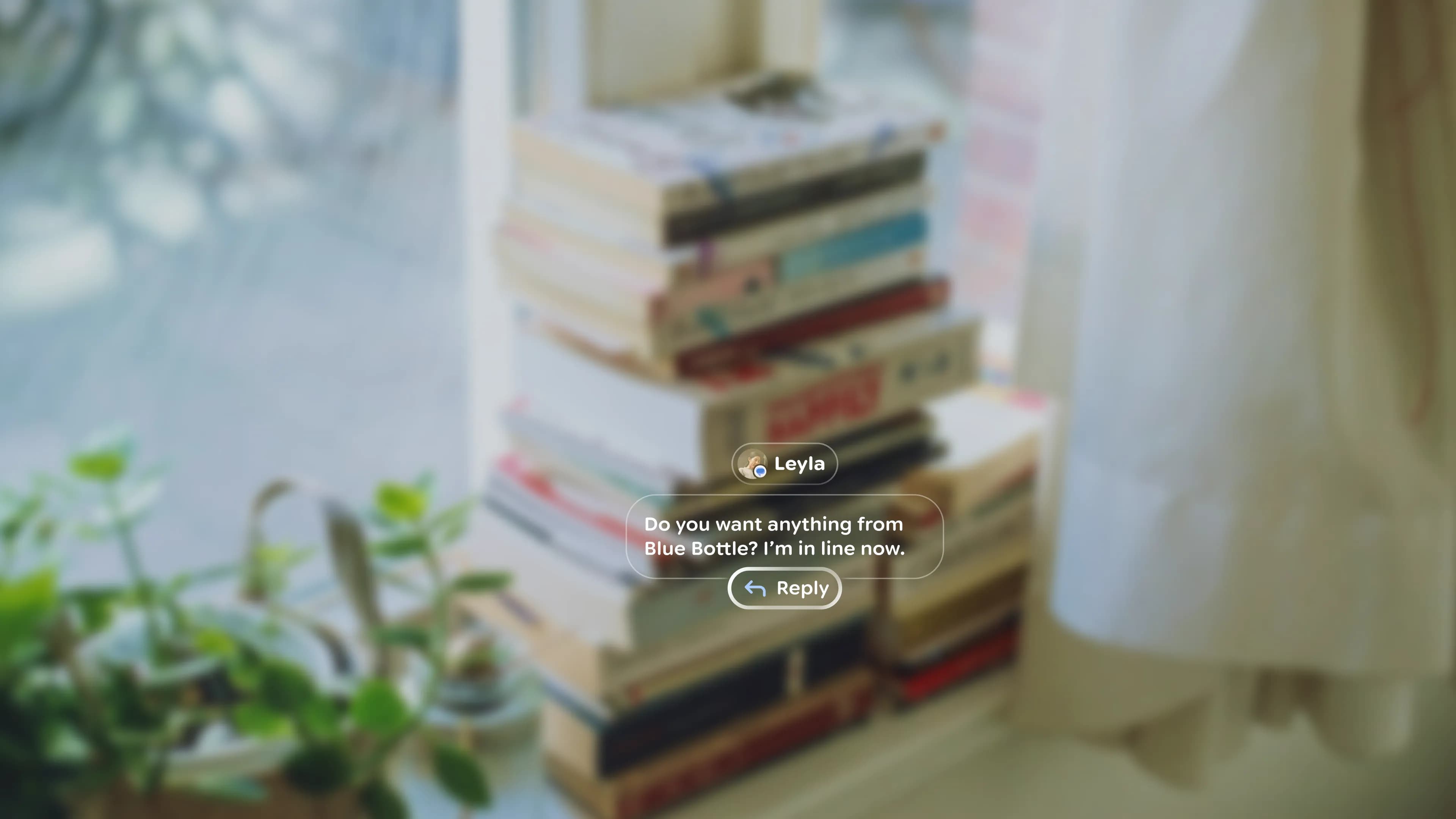 A text-message notification from a person named Leyla floats in front of a blurred stack of books on a windowsill.
