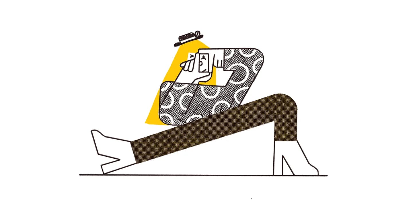 Person wearing a patterned top, brown pants, heeled boots, and a small hat takes a selfie.