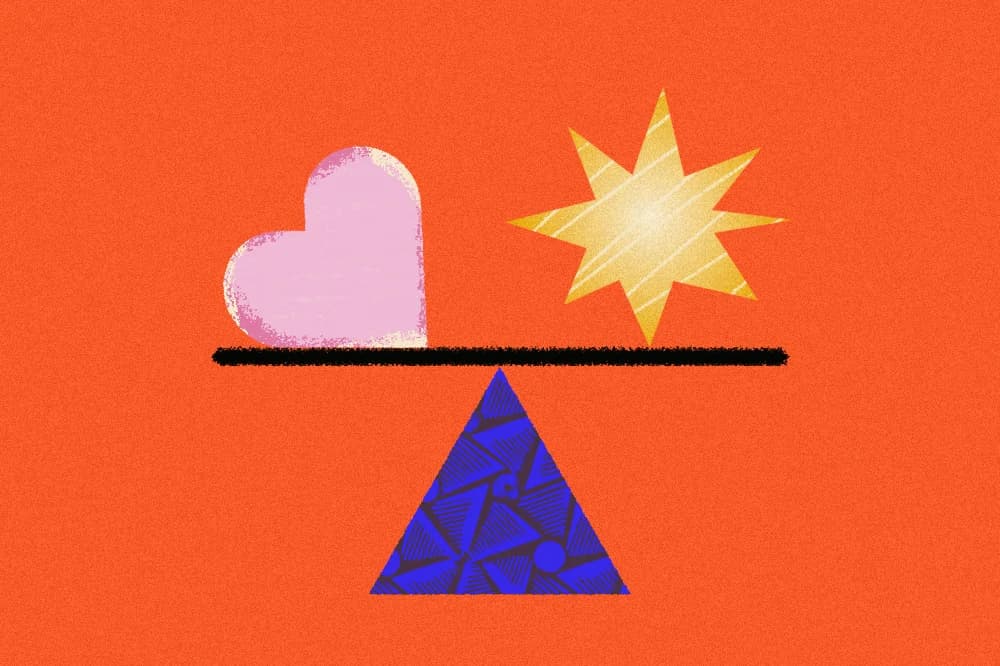 Pink heart and gold star balanced on seesaw.