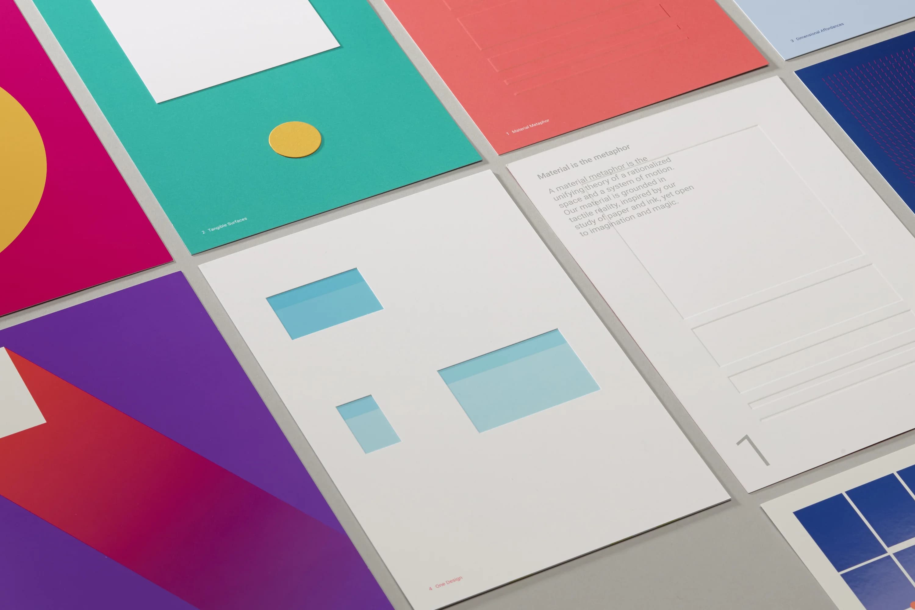 Close-up of colorful cards with geometric shapes and text.