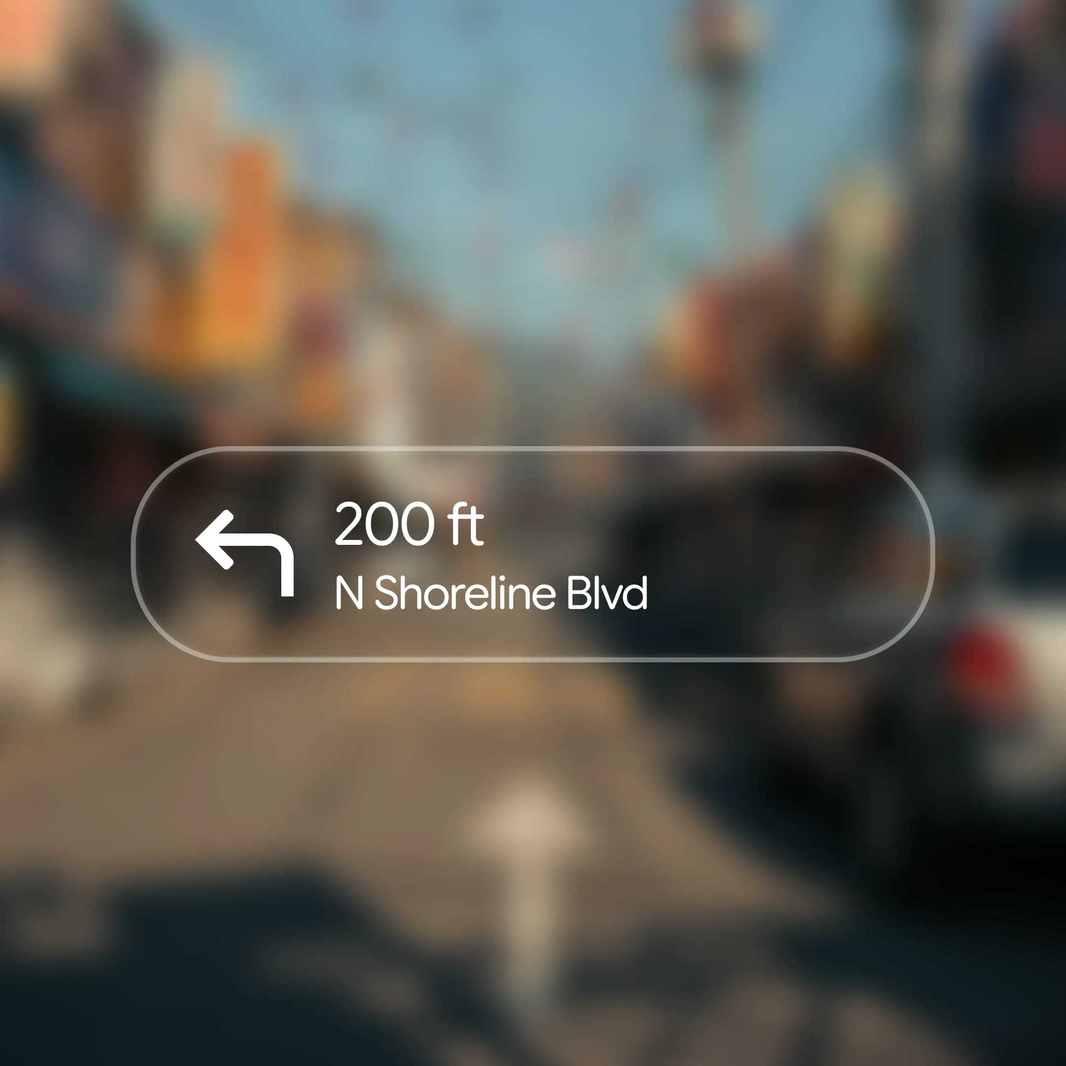 A navigation card for “N Shoreline Blvd” using thin, condensed white text that appears faint against the street background.