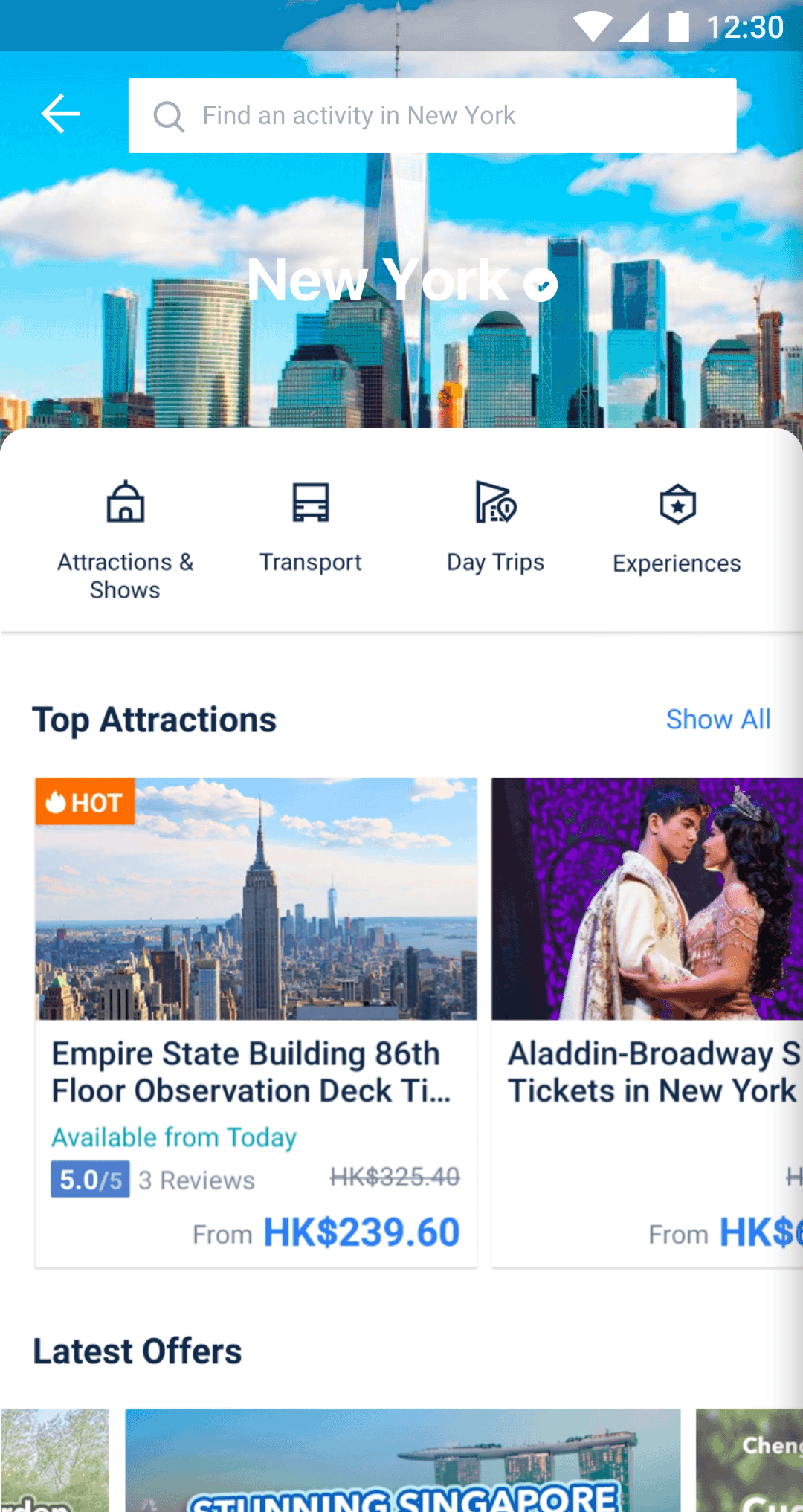 Screenshot of a travel app displaying New York City attractions. Options include Empire State Building tickets and Broadway's Aladdin.