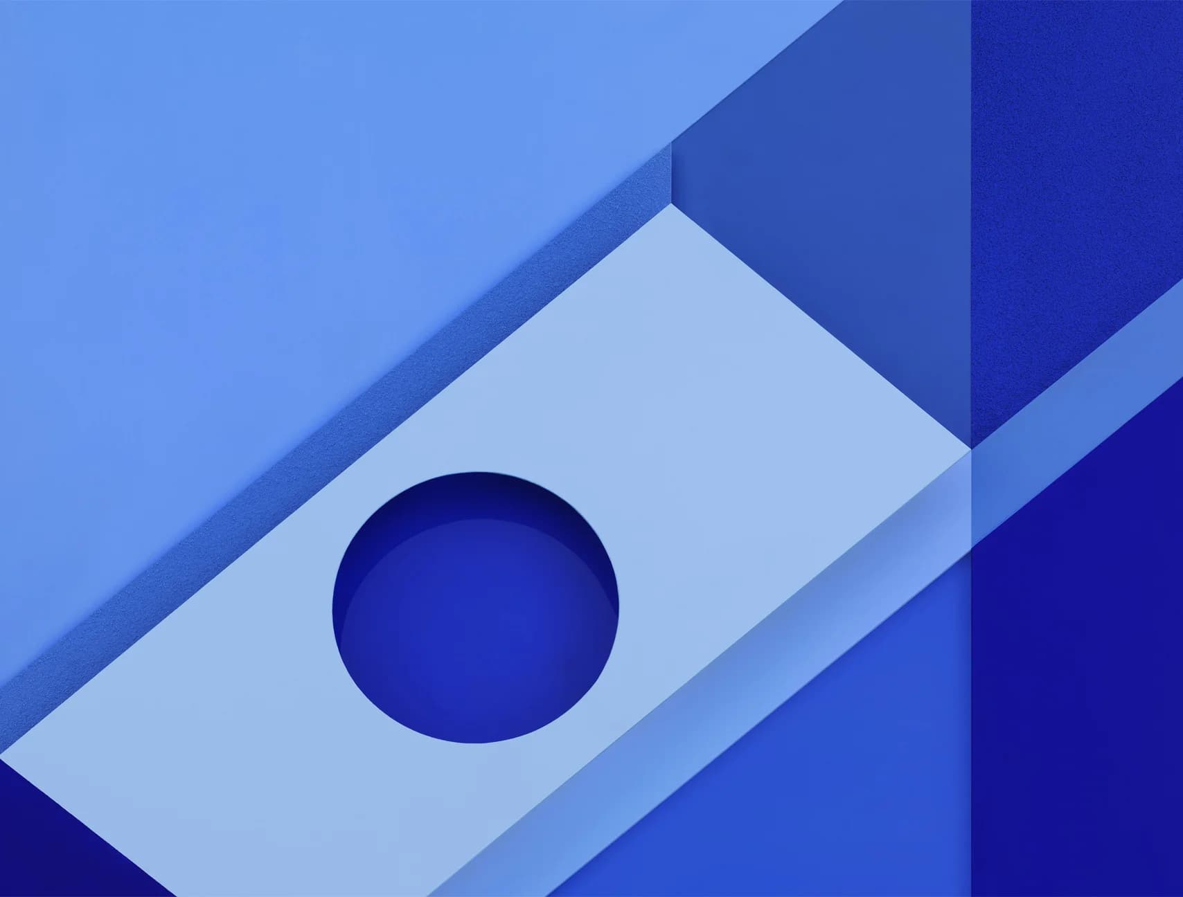 Abstract blue background with layered geometric shapes, including a rectangle with a circular cutout. Various shades of blue create depth.