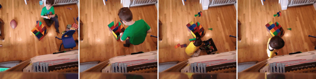 A toddler plays with colorful, magnetic blocks on a hardwood floor, seen from above. He builds, takes apart, and picks up the scattered pieces.