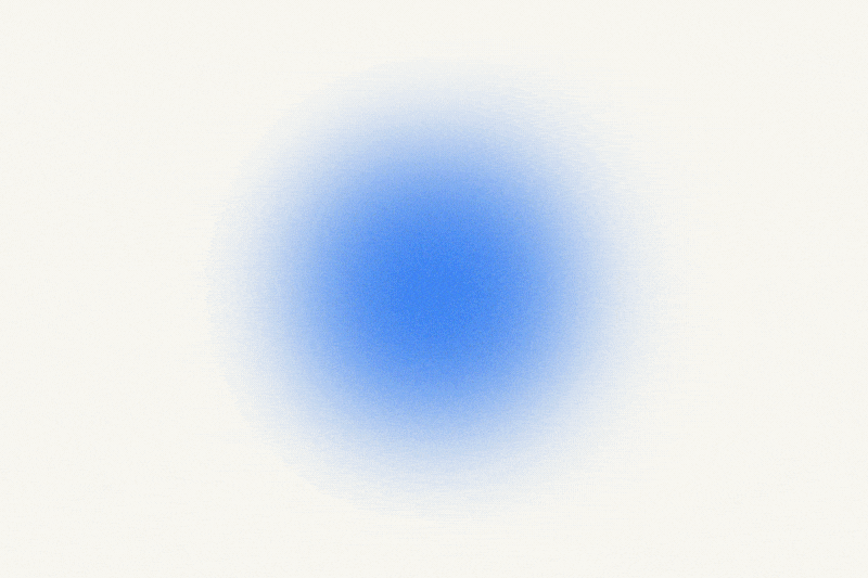 A soft, blurry, light blue circle on a white background.